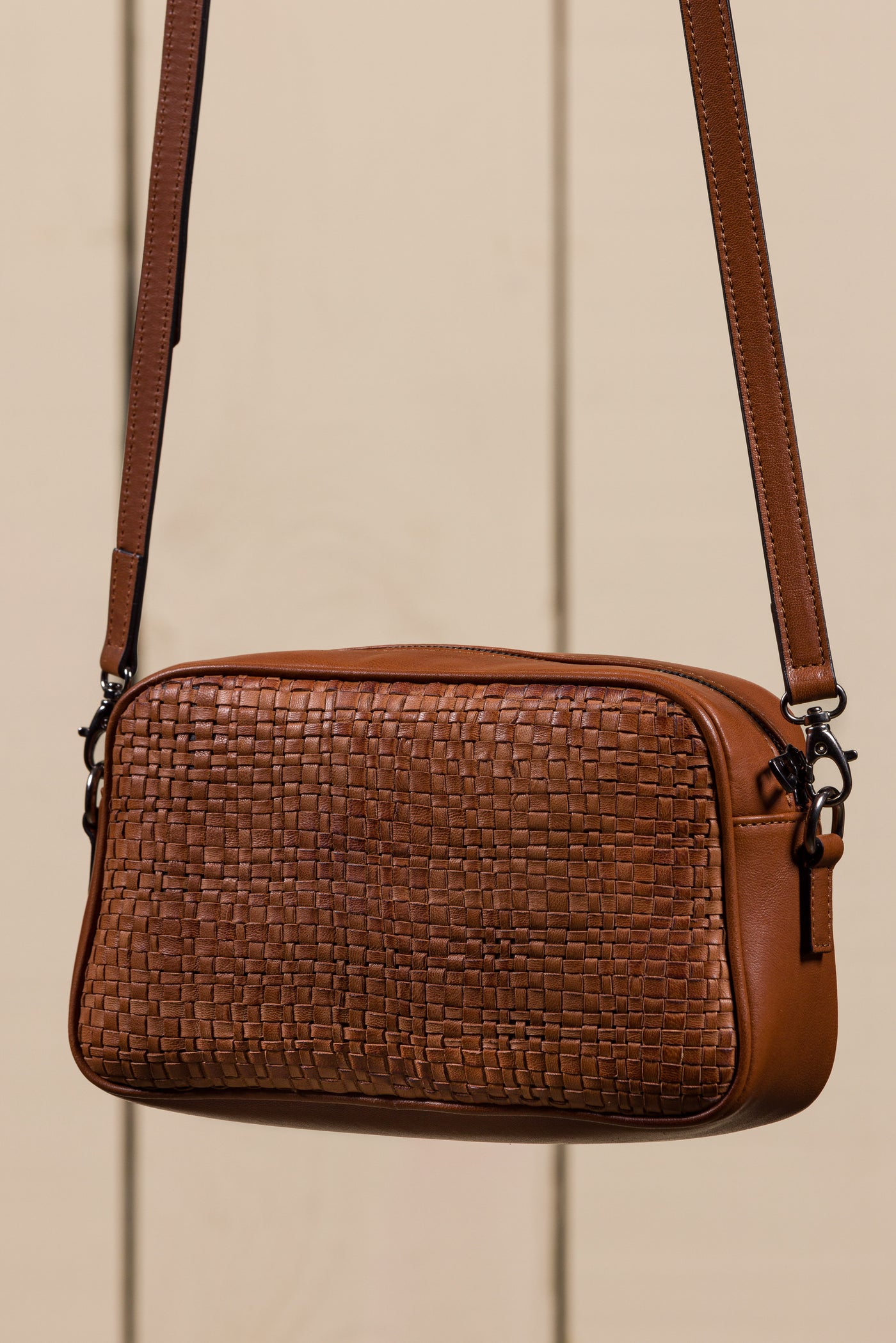 Back angled view of Afef Medium cuoio leather crossbody bag by Benheart.