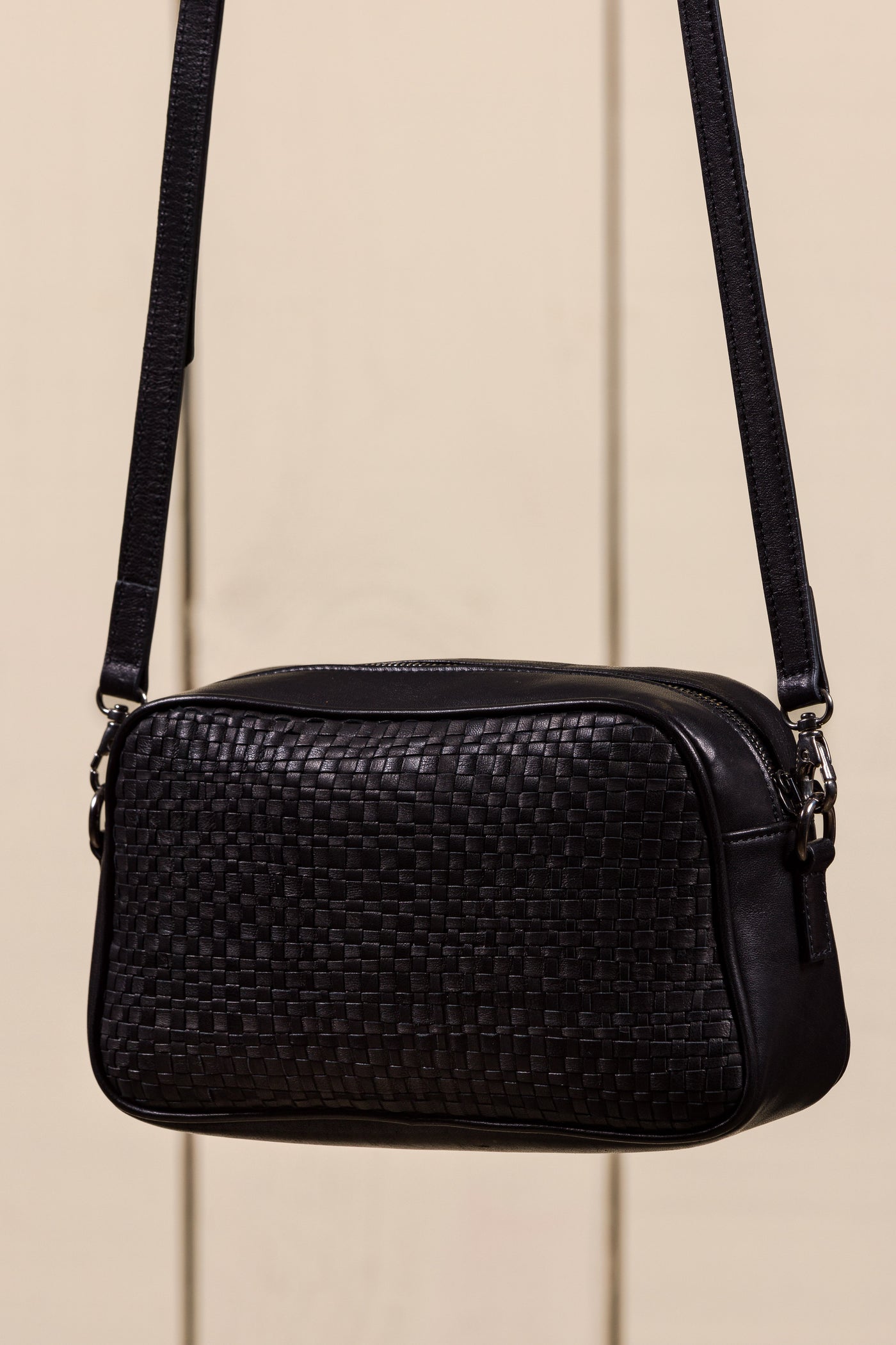 Back angled view of Afef Medium black leather crossbody bag by Benheart.