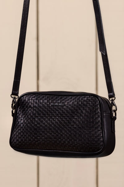 Front angled view of Afef Medium black leather crossbody bag by Benheart.