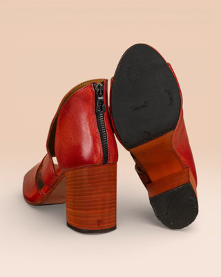 Rear view of Aria V443 women's porpora buffalo leather block heel sandals, left shoe standing, right shoe showing sole