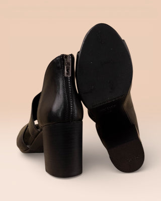 Rear view of Aria V443 women's black buffalo leather sandals by Benheart, left shoe upright, right shoe showing sole.
