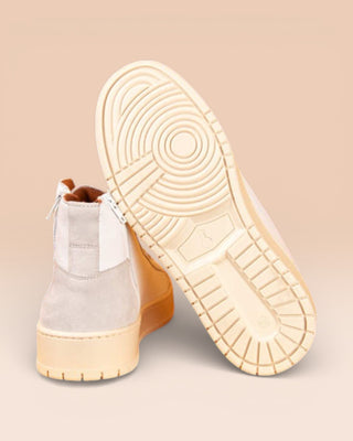 Rear view of one Bonetti 8473 unisex white leather high-top sneaker, while the other is angled to display the rubber sole.