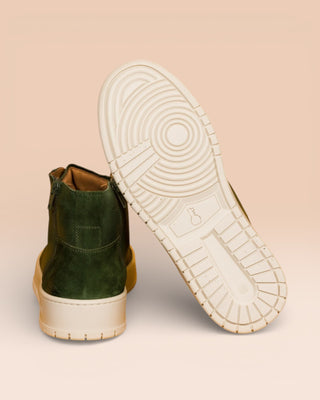 Rear view of one Bonetti 8473 unisex green leather high-top sneaker, while the other is angled to display the rubber sole.
