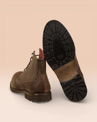 Detail of the Vibram sole of a pair of Benheart Daniel men’s brown leather lace-up brogue ankle boots with wingtip design