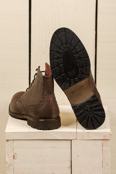 Detail of the Vibram sole of a pair of Benheart Daniel men’s brown leather lace-up brogue ankle boots with wingtip design