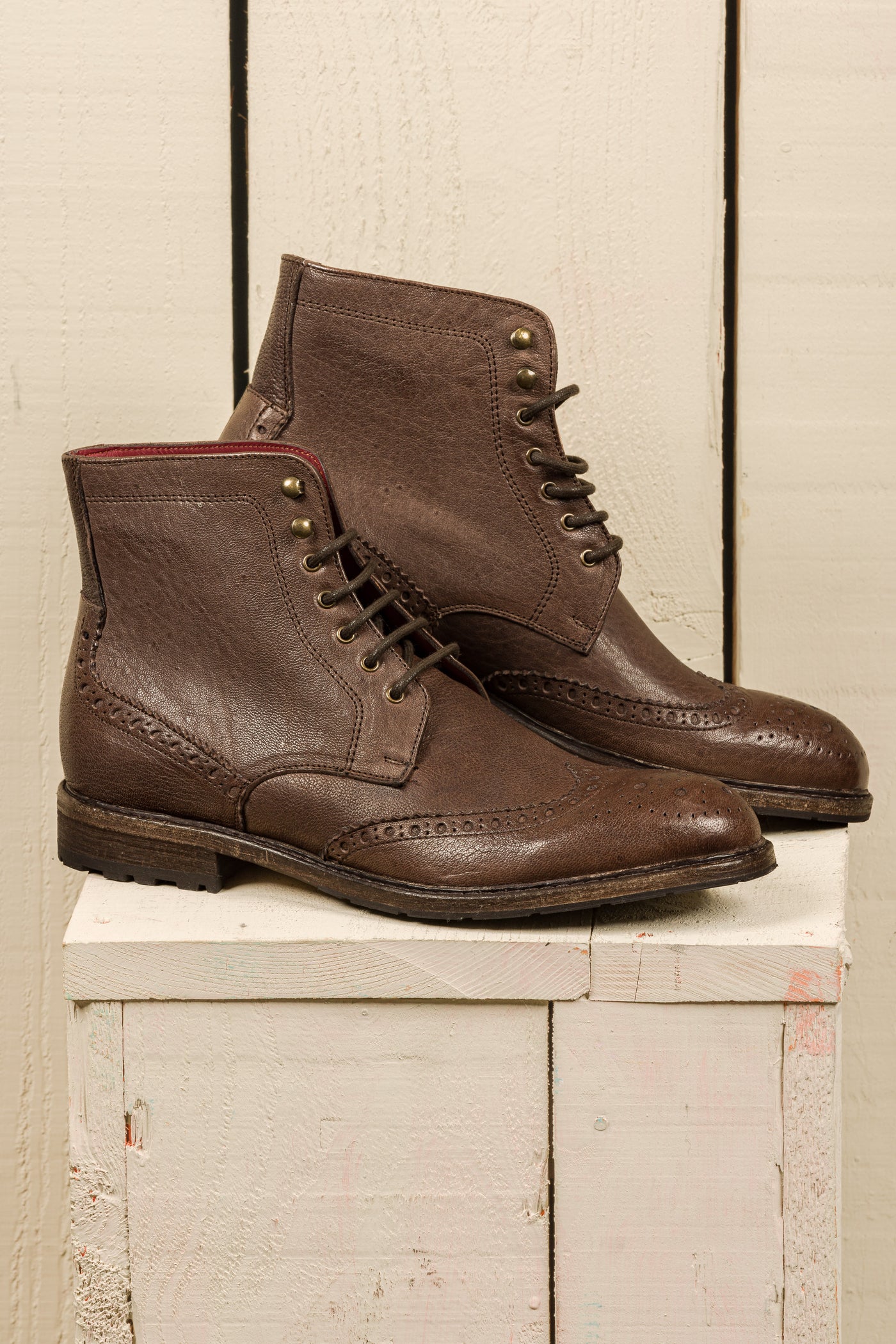 Side view of a pair of Daniel men’s leather lace-up brogue ankle boots with wingtip design, handmade by Benheart in brown
