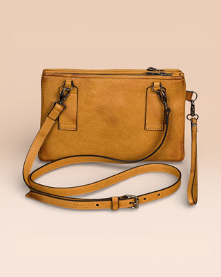 Back view of the Benheart Desert Pochette leather clutch in mahogany, showing the adjustable shoulder strap and smooth leather finish.