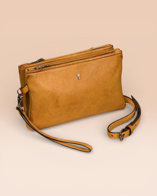 Front angled view of the Benheart Desert Pochette double-zip woven leather clutch in mahogany, made in Italy.