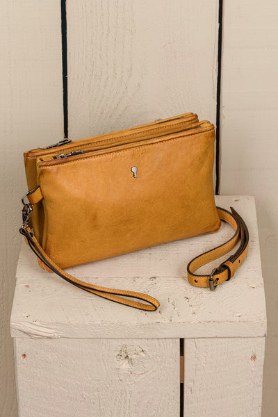 Front angled view of the Benheart Desert Pochette double-zip woven leather clutch in mahogany, made in Italy.