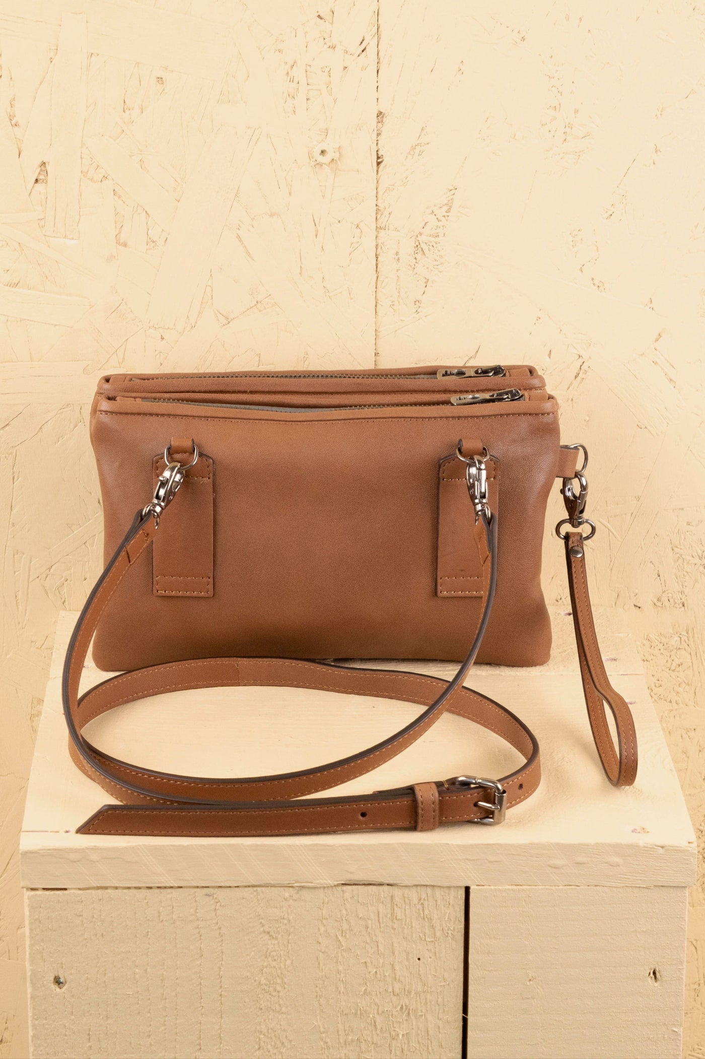 Rear view of the Benheart Desert Pochette Borchiata in Cuoio color.