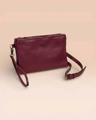 Front angled view of the Benheart Desert Pochette double-zip woven leather clutch in prugna, made in Italy.