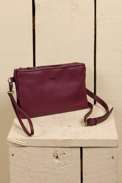 Front angled view of the Benheart Desert Pochette double-zip woven leather clutch in prugna, made in Italy.