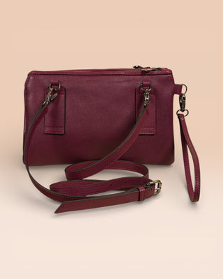 Rear view of the Benheart Desert Pochette leather clutch in prugna.