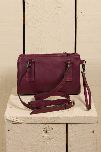 Rear view of the Benheart Desert Pochette leather clutch in prugna.