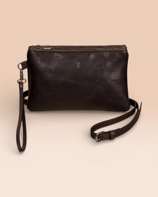 Front view of the Benheart Desert Pochette leather clutch in testa di moro dark brown, highlighting the two zippered compartments and adjustable shoulder strap.