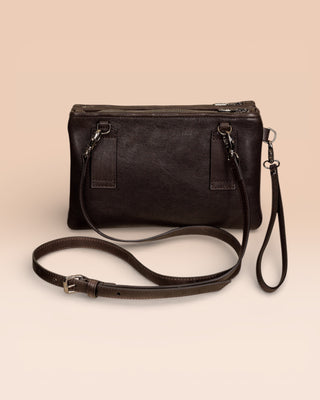 Back view of the Benheart Desert Pochette leather clutch in dark brown, showing the adjustable shoulder strap and smooth leather finish.