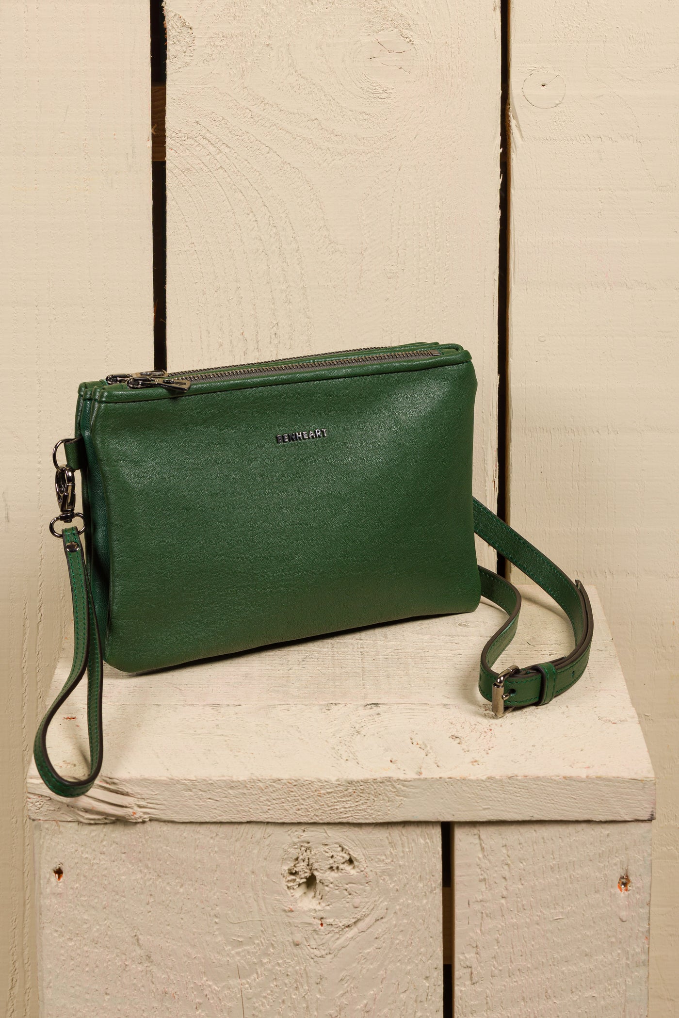 Front angled view of the Benheart Desert Pochette double-zip woven leather clutch in green, made in Italy.