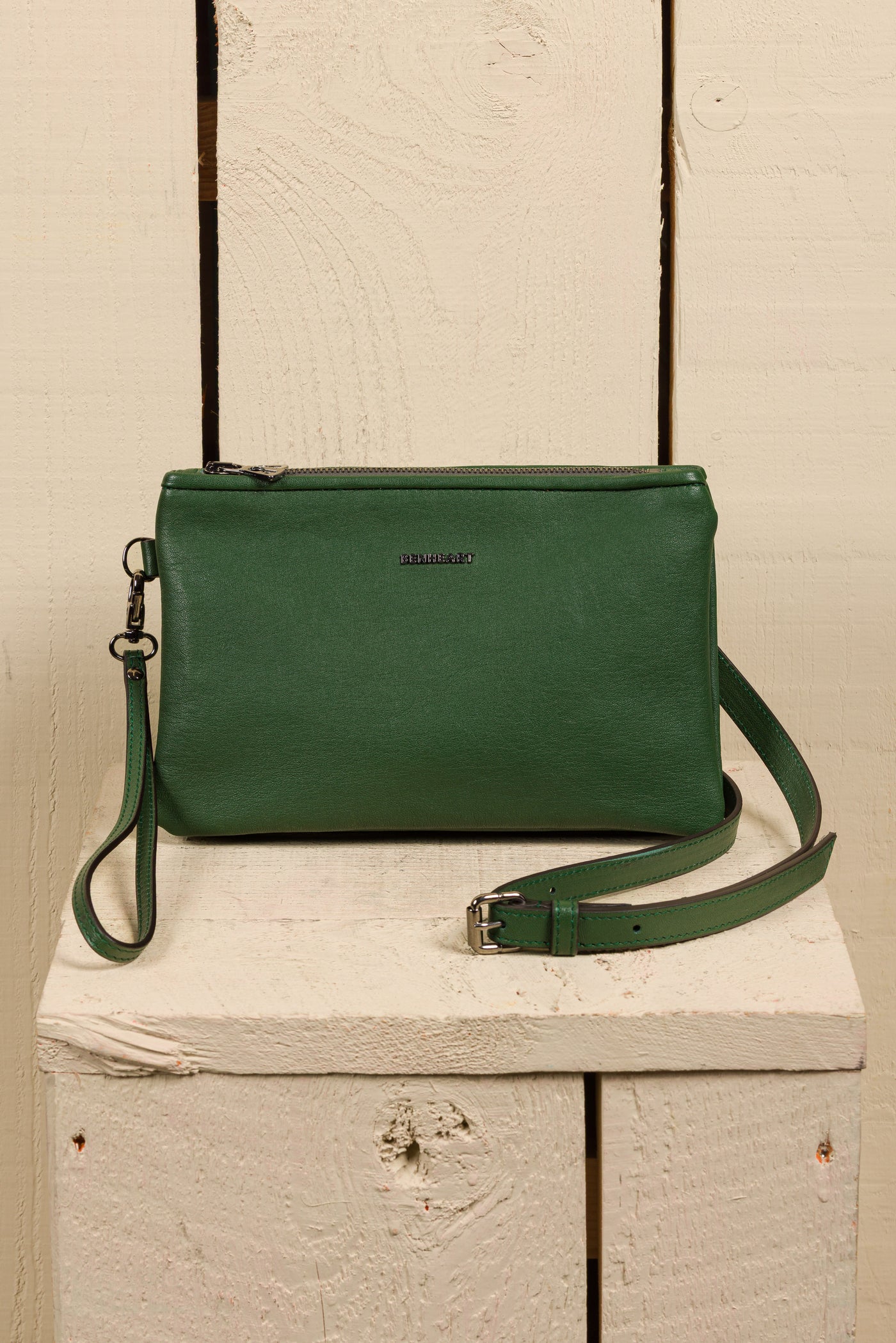 Front view of the Benheart Desert Pochette leather clutch in green, highlighting the two zippered compartments and adjustable shoulder strap.