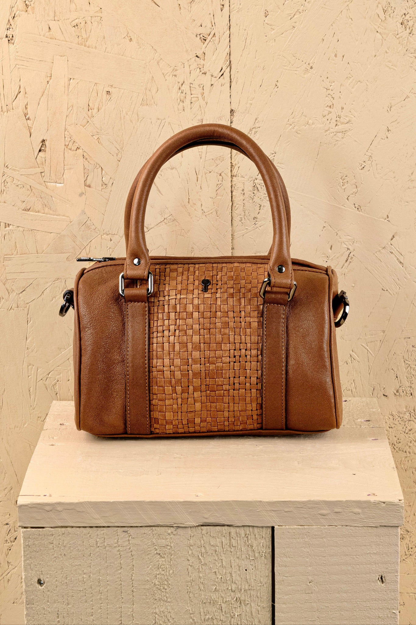 Front view of Benheart Dom Intrecciata tan leather bag, featuring woven central panel.