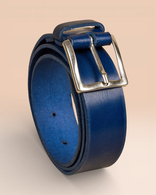 Vertical angled view of FIRENZE Benheart belt in deep blue leather, rolled view on neutral background