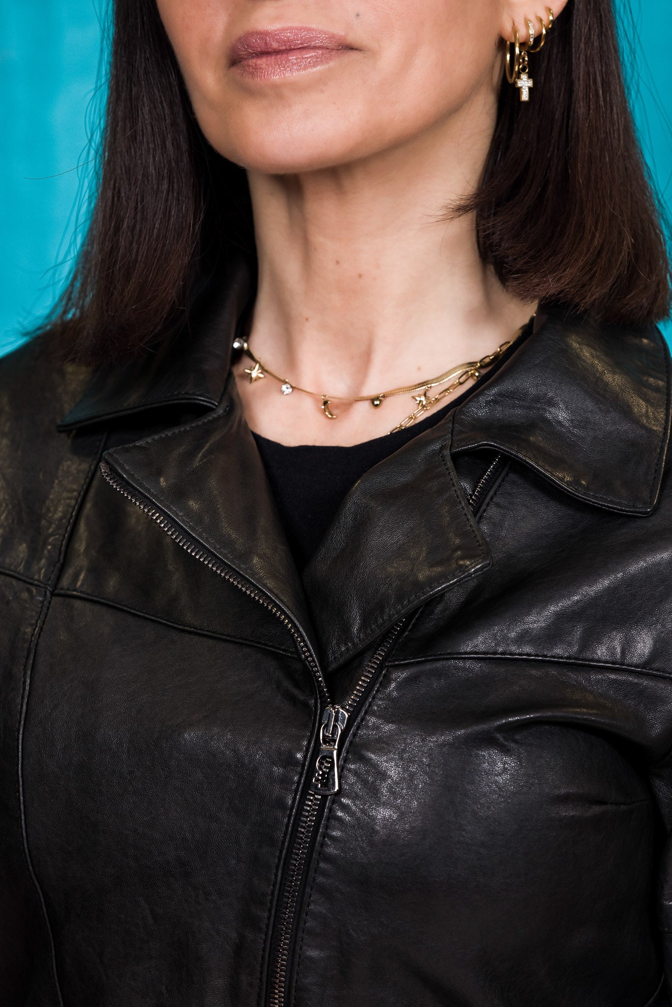Close-up of neckline and Benheart logo zipper on Fede black women's leather jacket.