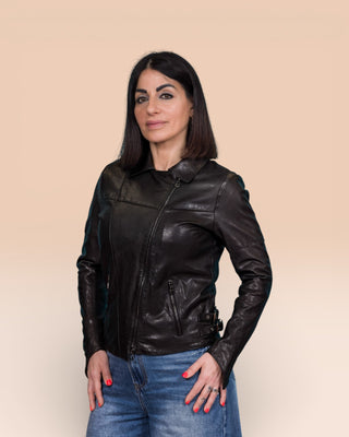 Model wearing Fede black women's leather biker jacket, closed, front 3/4 view.