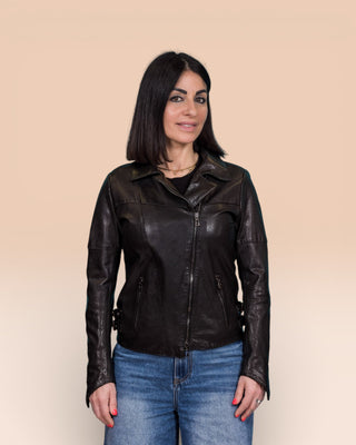Model wearing Fede black women's leather biker jacket, front view, jacket closed, collar open.