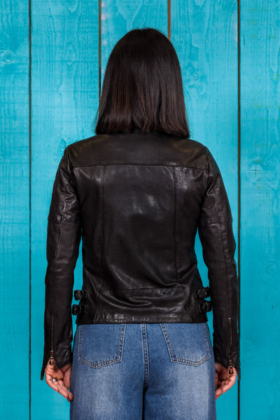 Rear view of model in Fede women's black leather jacket.