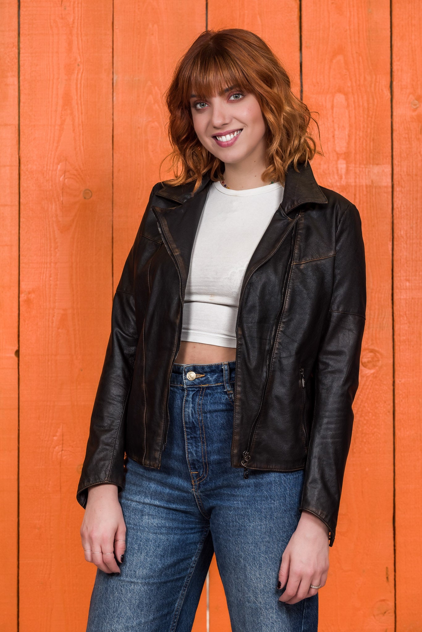 Model wearing Fede Special beige women's leather biker jacket, open, front 3/4 view.