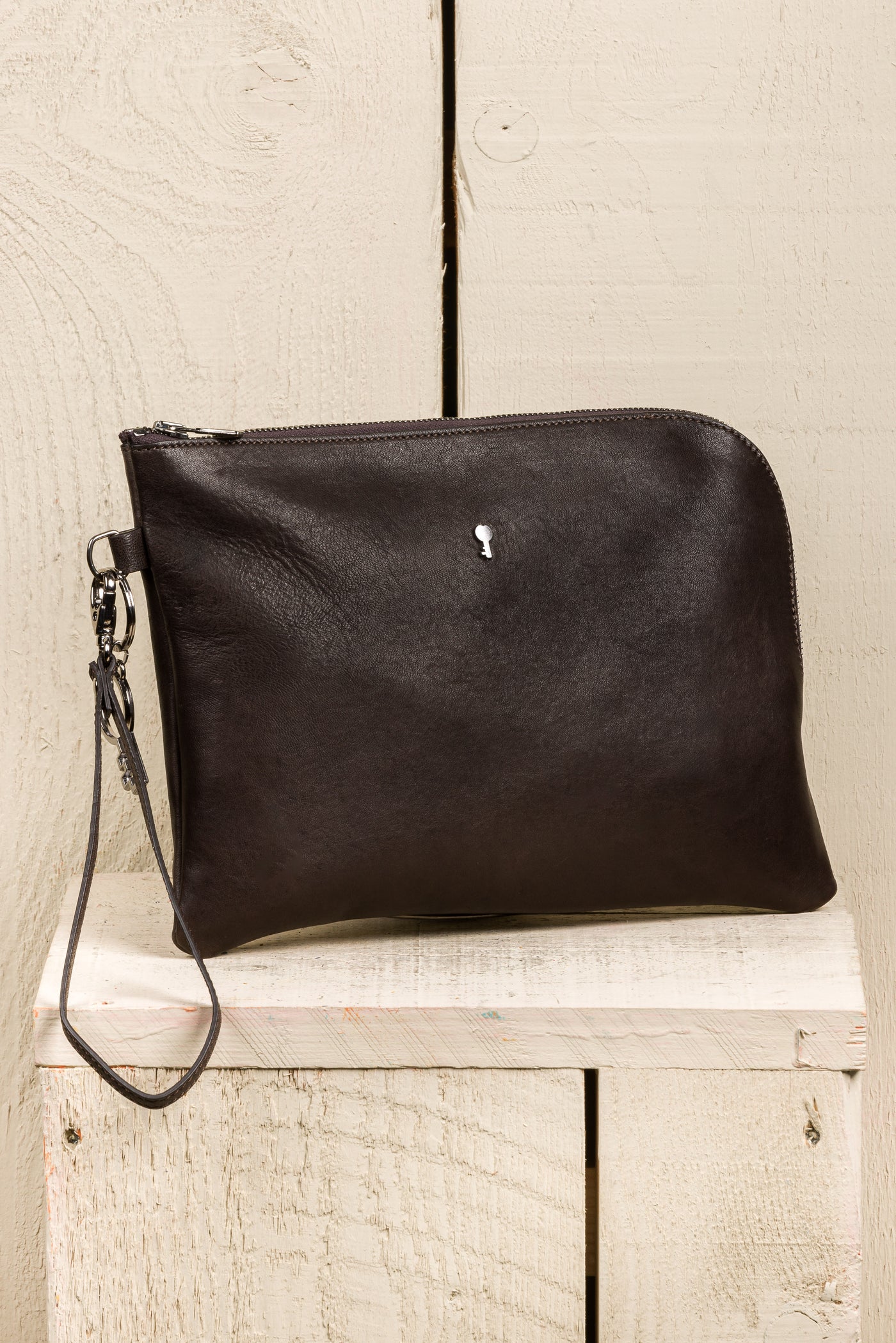 Benheart Gigi dark brown testa di moro leather pouch, handmade in Italy, angled front view.