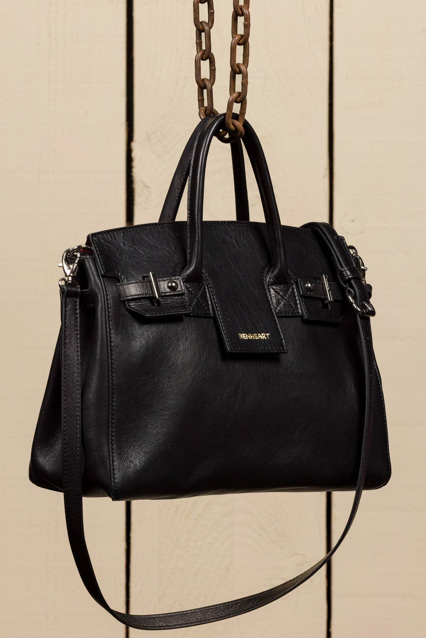 Ginevra Small black lamb leather bag, front three-quarter view with gold Benheart logo.