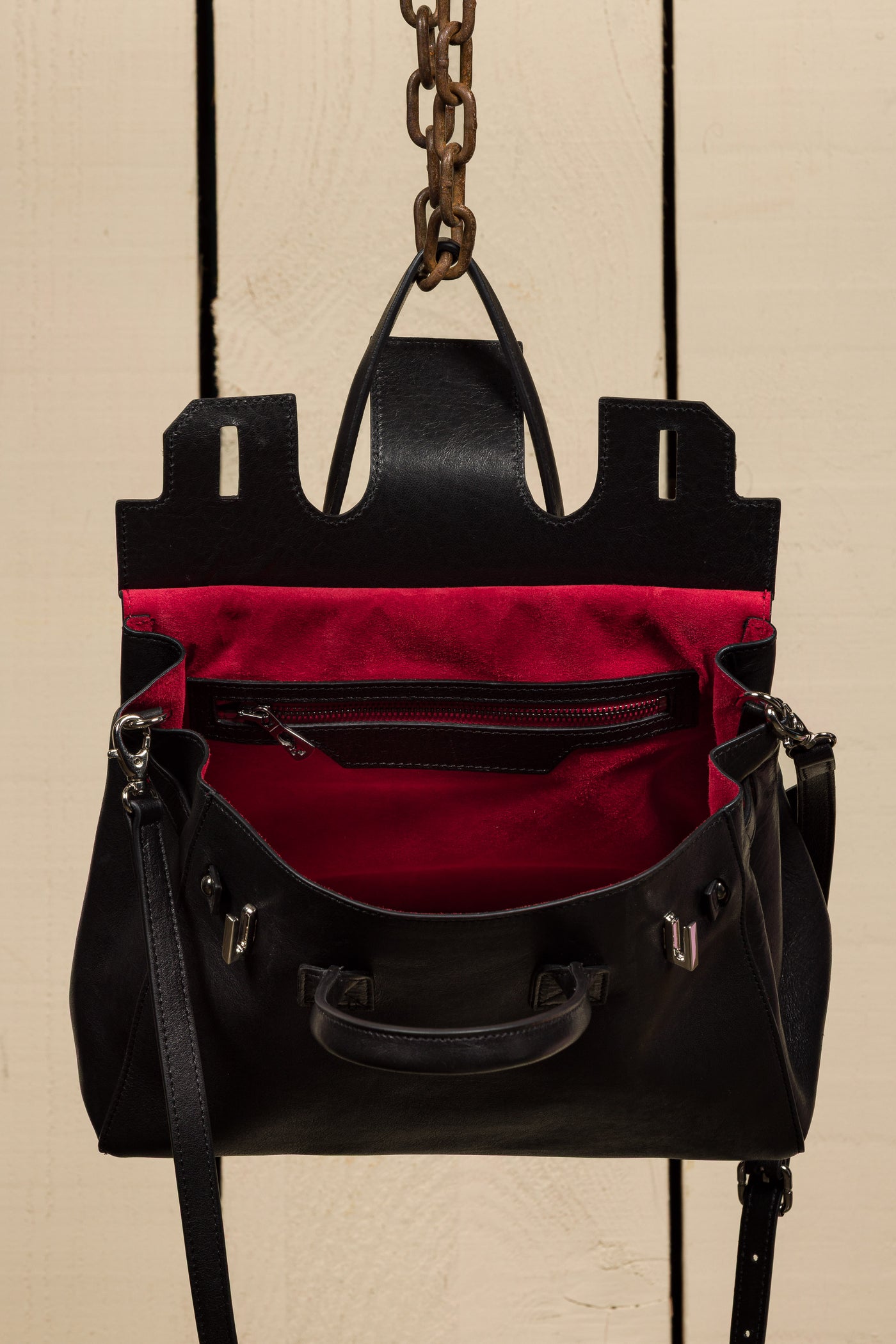 Ginevra Small Benheart black lamb leather bag, front angled view showing open red interior.