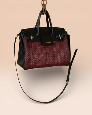 Front angled view of Benheart Ginevra Small Intrecciata woven lamb leather bag in plum.