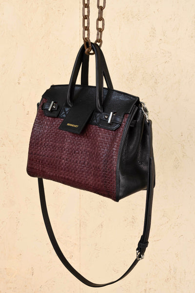 Front angled view of Benheart Ginevra Small Intrecciata woven lamb leather bag in plum.