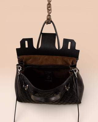 Ginevra Small Trapuntata women’s black quilted leather handbag by Benheart, angled front view showing open interior.