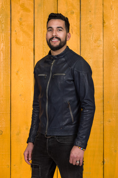 Front angled view of a model wearing the blue Hich leather jacket by Benheart.