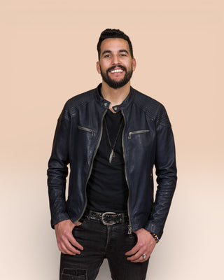 Front view of a model wearing the blue Hich leather jacket by Benheart, worn open.