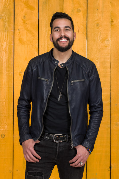 Front view of a model wearing the blue Hich leather jacket by Benheart, worn open.