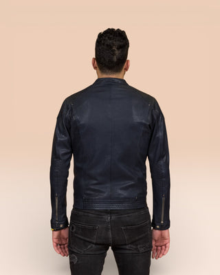Back view of a model wearing the blue Hich leather jacket by Benheart.