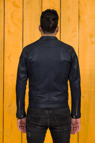 Back view of a model wearing the blue Hich leather jacket by Benheart.