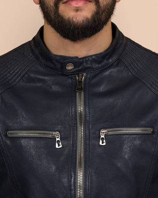 Close-up of the blue Hich jacket’s front zipper and chest pockets with Benheart logo-shaped zipper pulls.