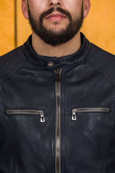 Close-up of the blue Hich jacket’s front zipper and chest pockets with Benheart logo-shaped zipper pulls.