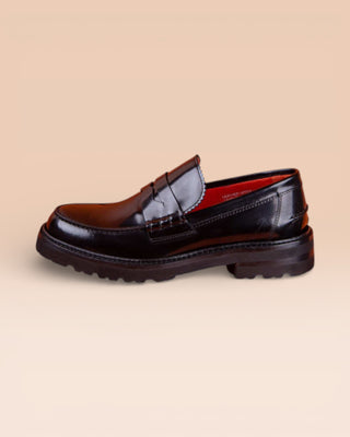 Benheart Ida Mocassino women’s penny loafer in polished black cordovan leather, side view.