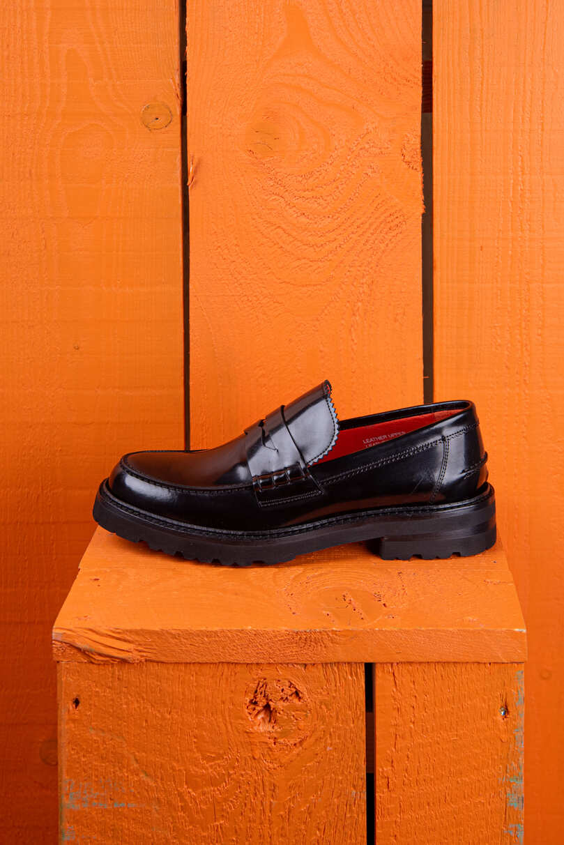 Benheart Ida Mocassino women’s penny loafer in polished black cordovan leather, side view.