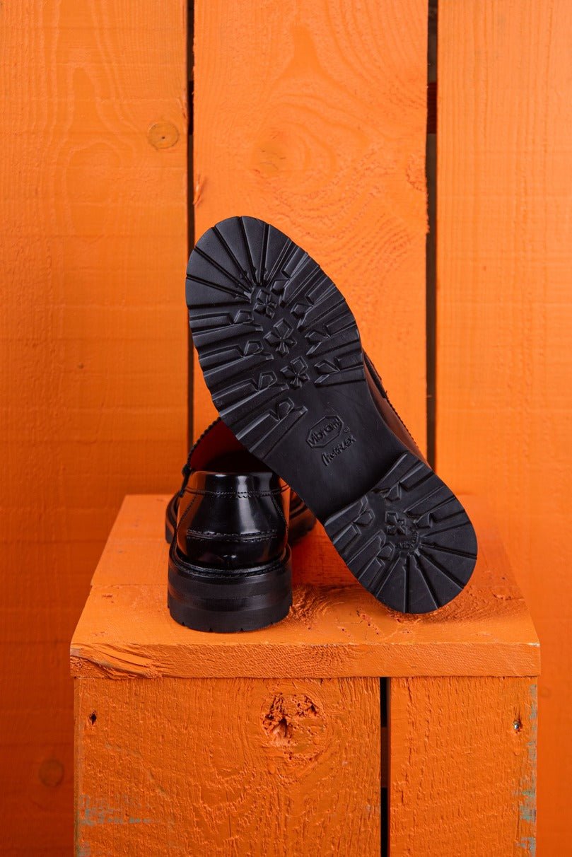 Benheart Ida Mocassino women’s penny loafers in polished black cordovan leather, rear view with one shoe showing the heel