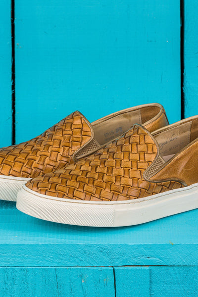 Close up view of Iris unisex woven slip-on shoes in mahogany leather with white rubber soles.