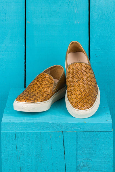 Front angled and top view of Iris unisex woven slip-on shoes in mahogany leather with white rubber soles.