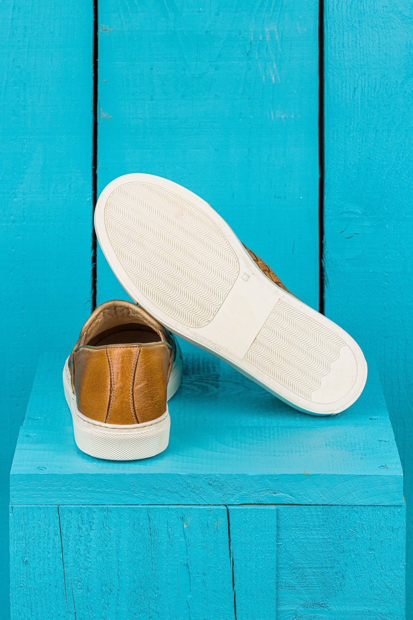 Rear view of Benheart Iris woven mahogany leather slip-on shoes, one showing the heel and the other the rubber sole.