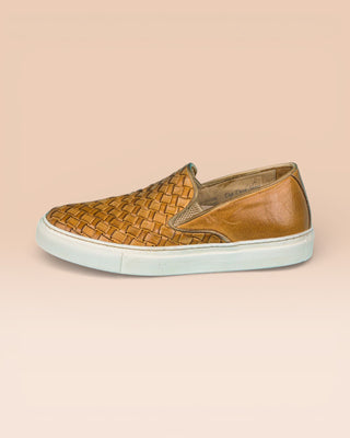 Side view of Iris unisex woven slip-on shoes in mahogany leather with white rubber soles.
