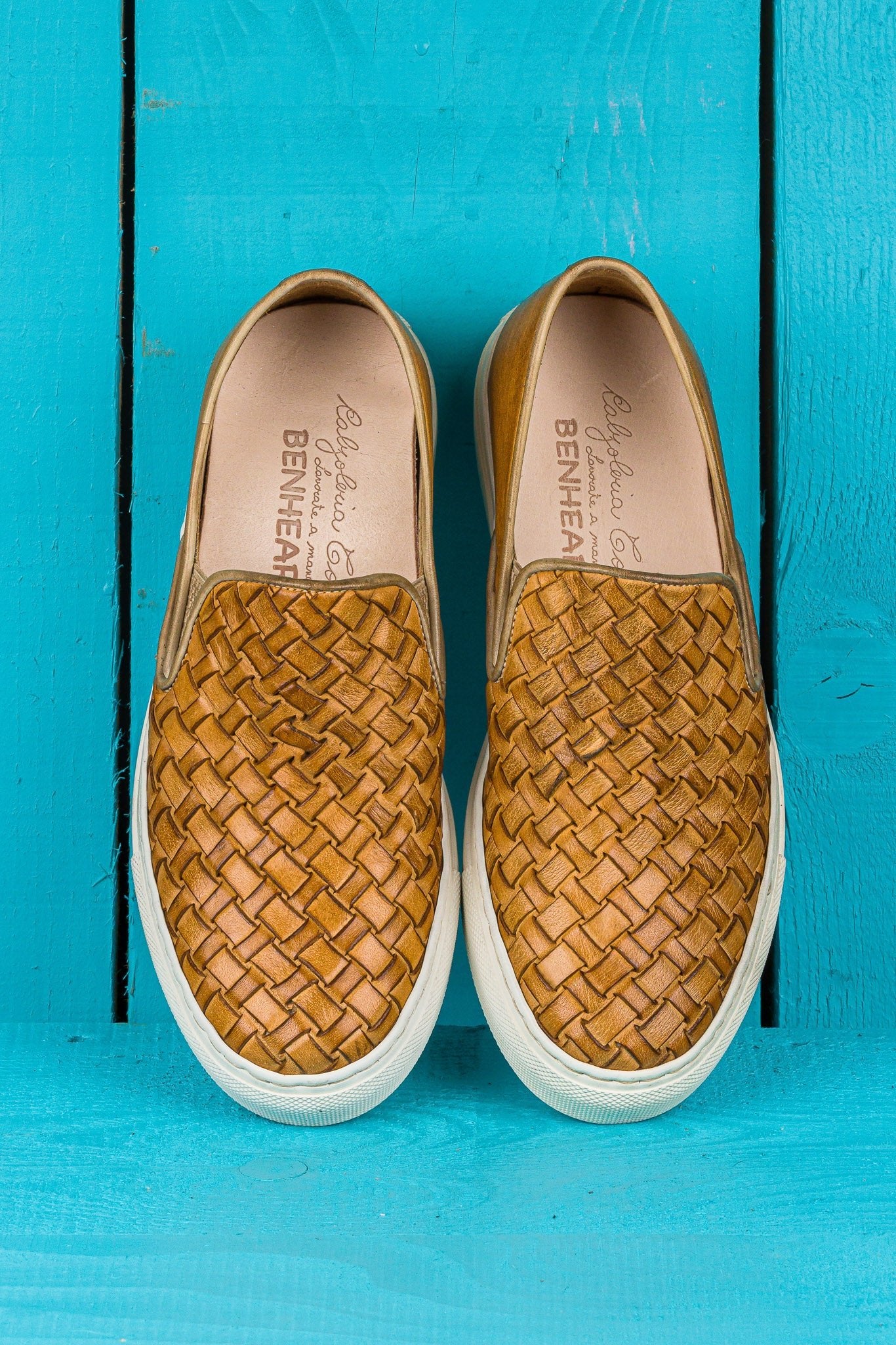 Top view of Iris unisex woven slip-on shoes in mahogany leather with white rubber soles.